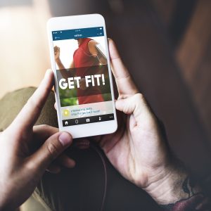 Man holding mobile with fitness app