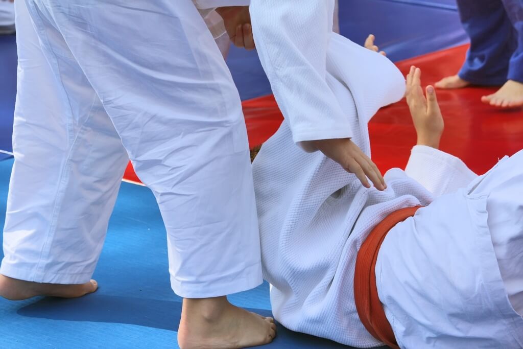 Person on mats in karate class